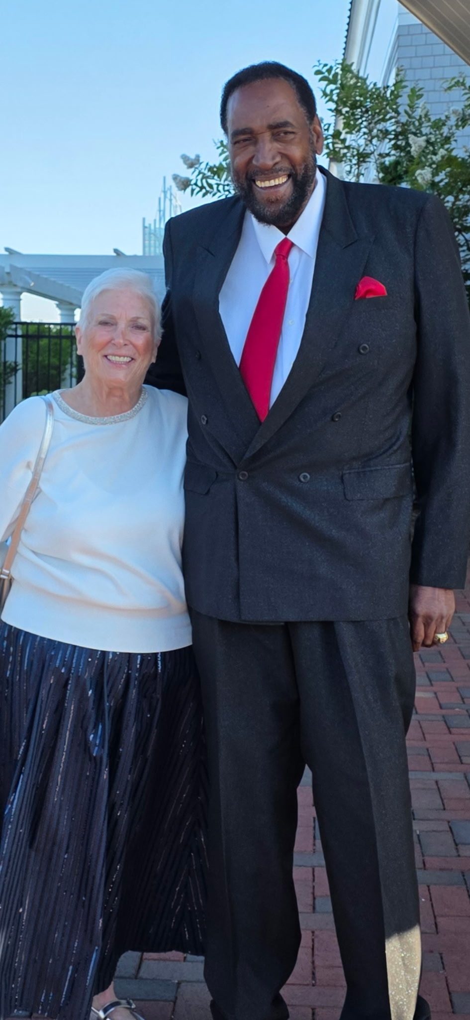 Coach Clifford Ray in a suit and red tie