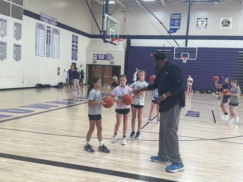 Coach Ray running a drill with a group of girls